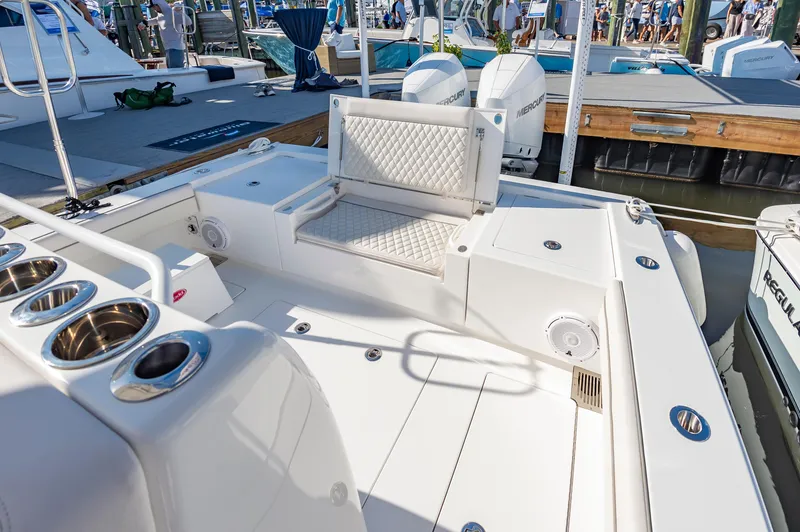Slide: The Image of 2025 Valhalla Boatworks V-29 deck with seating and cup holders at marina. - 30