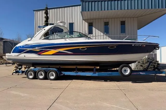 Slide: The Image of 2008 Formula 350 Sun Sport boat on trailer, parked outside a building. - 0