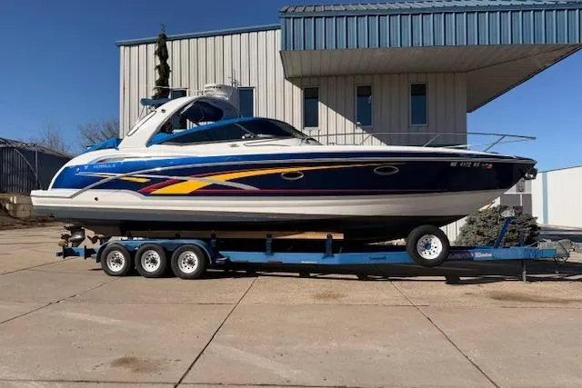 Slide: The Image of 2008 Formula 350 Sun Sport boat on trailer, parked outside a building. - 12
