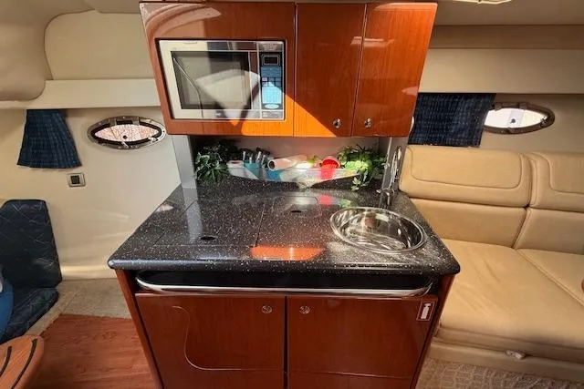 Slide: The Image of Interior of 2008 Formula 350 Sun Sport boat with kitchenette and seating area. - 16