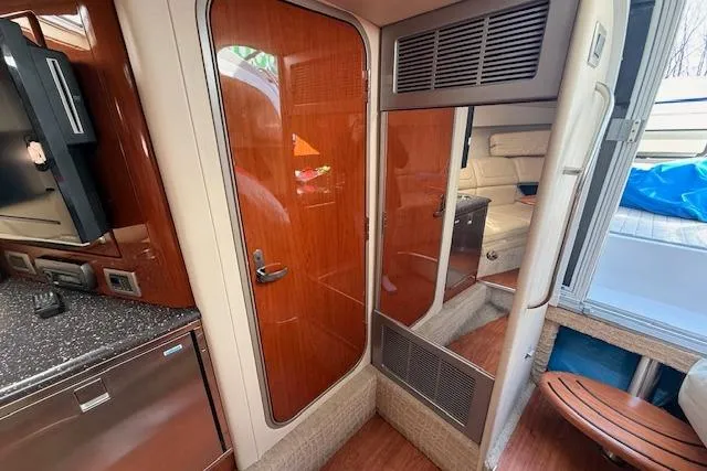 Slide: The Image of Interior of a 2008 Formula 350 Sun Sport boat, featuring wood finishes and modern amenities. - 18