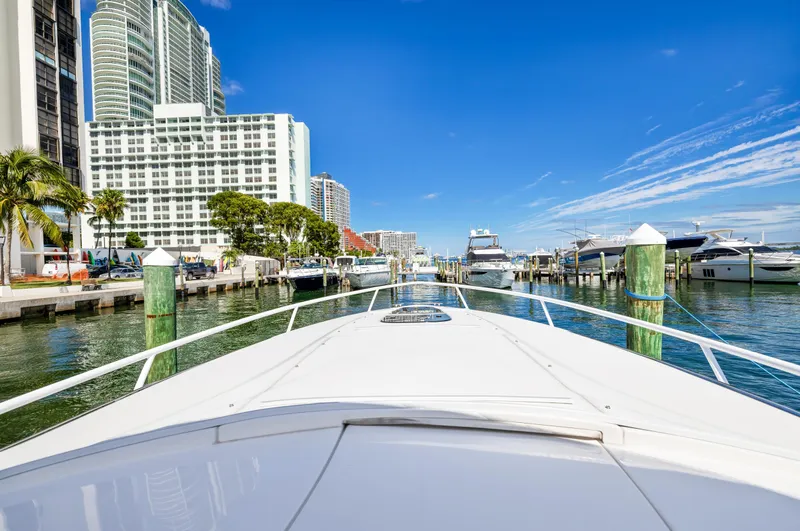 Slide: The Image of View from the bow of a 2016 Intrepid 400 Cuddy yacht in a marina. - 10