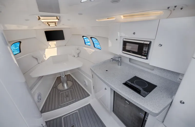Slide: The Image of Interior of a 2016 Intrepid 400 Cuddy boat with modern kitchen and seating area. - 18