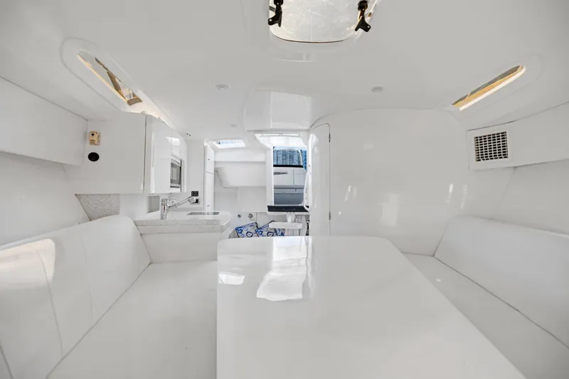 Slide: The Image of Interior of 2016 Intrepid 400 Cuddy boat with white seating and kitchenette. - 22