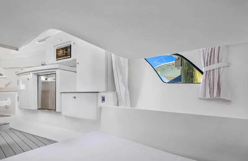 Slide: The Image of Interior of 2016 Intrepid 400 Cuddy with kitchenette and window view. - 26