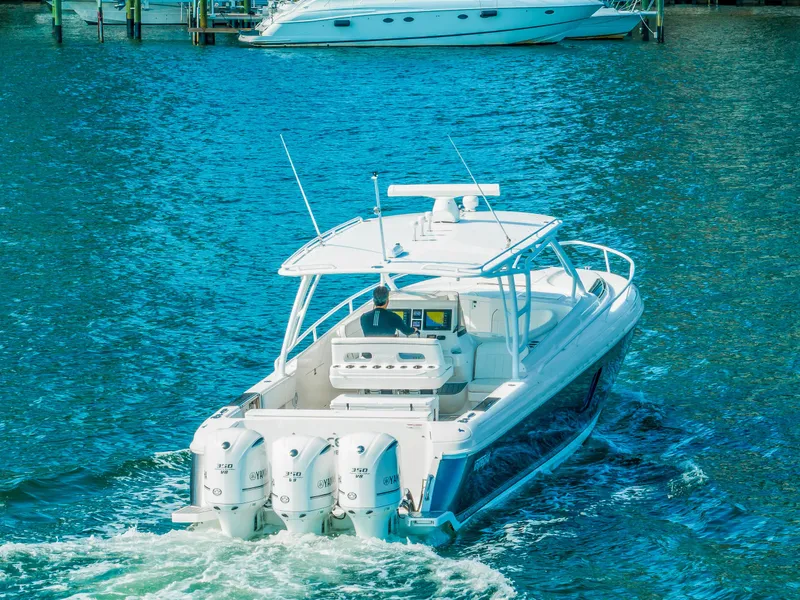 Slide: The Image of 2016 Intrepid 400 Cuddy boat cruising on blue water. - 6
