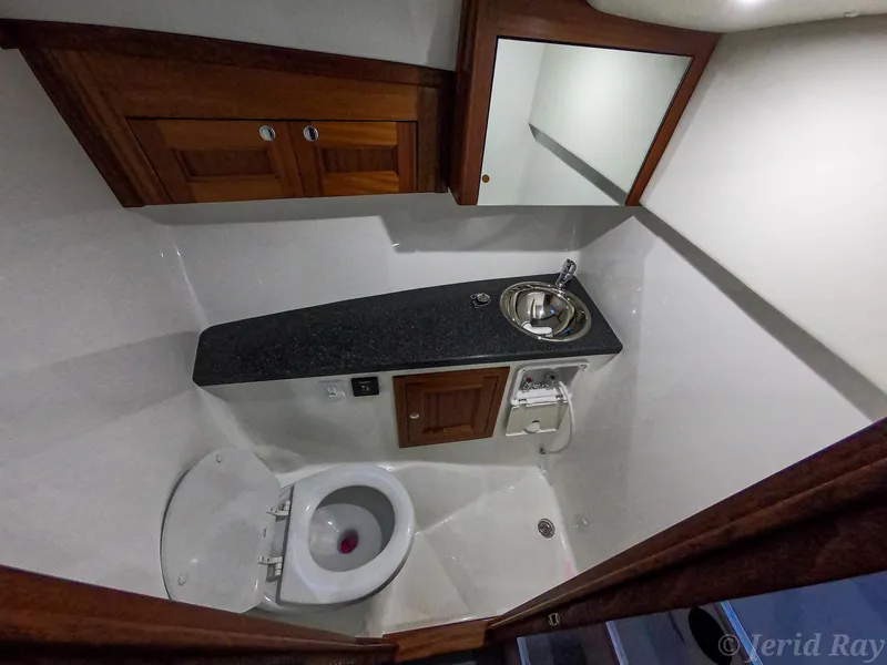 Slide: The Image of Luxurious 2025 Ocean Sport Roamer bathroom with modern fixtures and wooden cabinetry. - 2