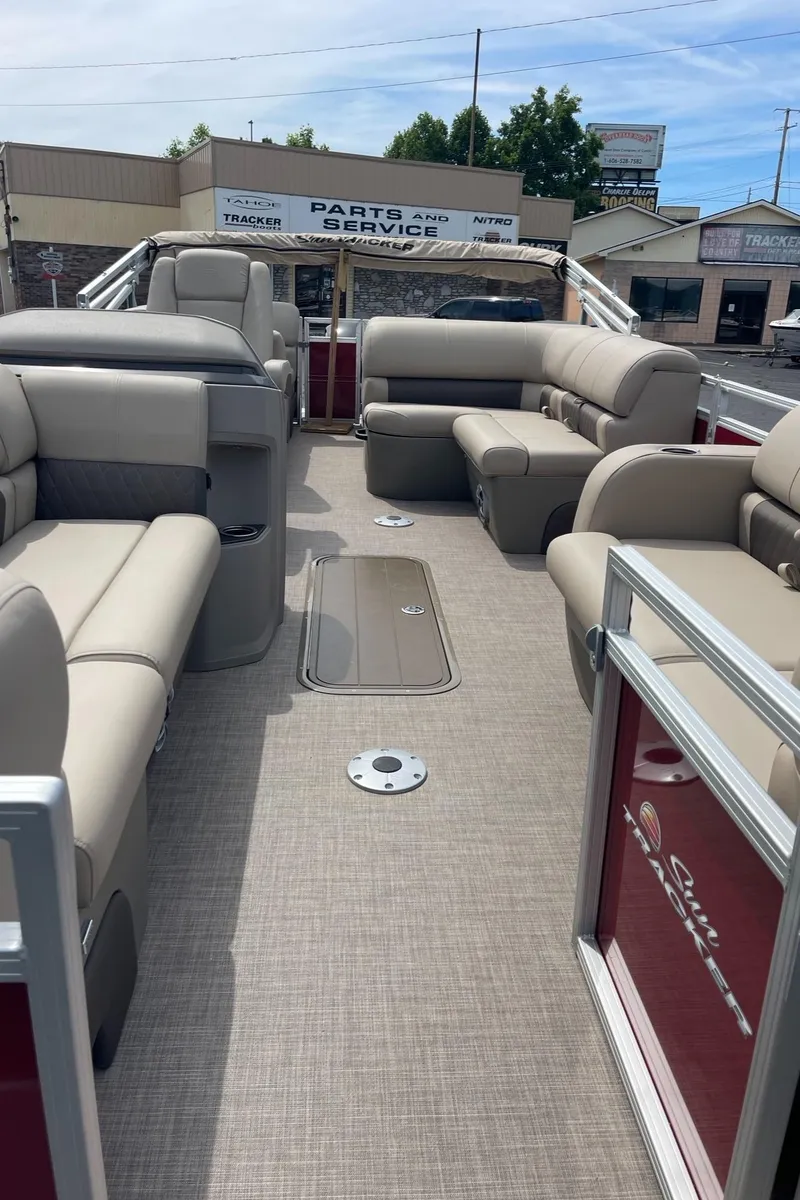 Slide: The Image of 2024 Sun Tracker Party Barge 22 RF XP3 interior with beige seating and spacious layout. - 10