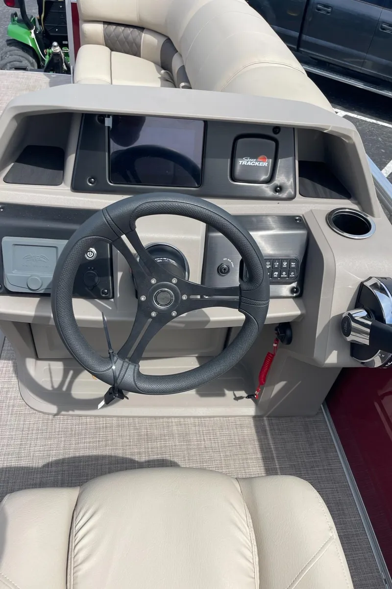 Slide: The Image of 2024 Sun Tracker Party Barge 22 RF XP3 steering console with modern controls and comfortable seating. - 8