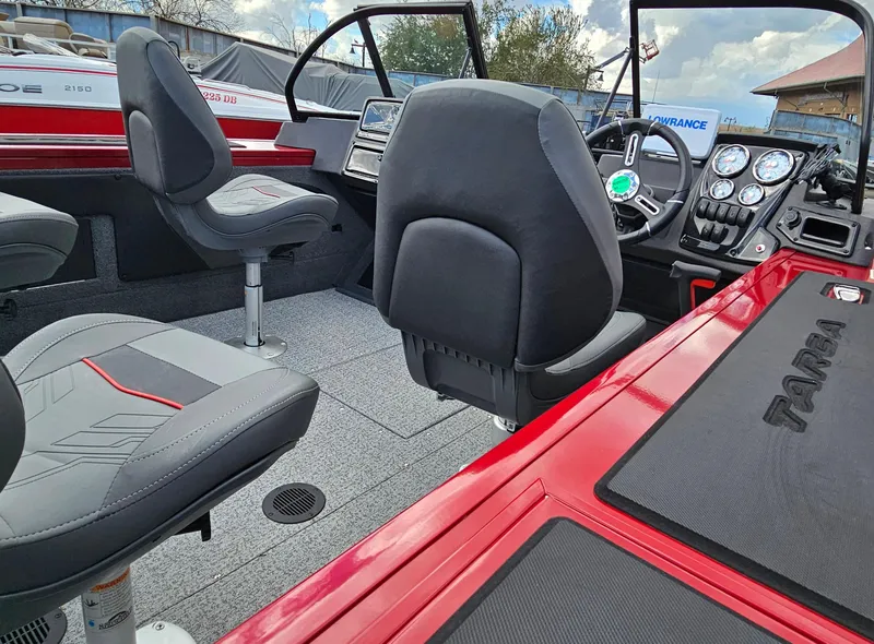 Slide: The Image of 2024 Tracker Targa V-19 WT boat interior with seats and dashboard. - 2