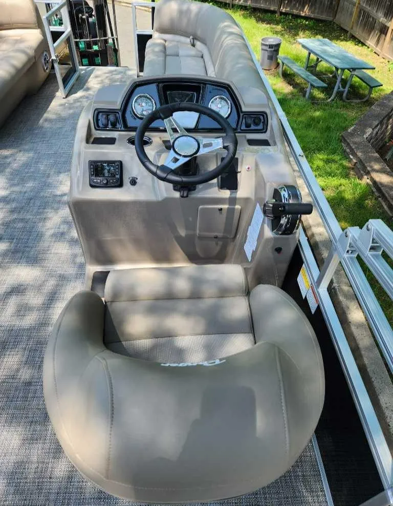 Slide: The Image of 2024 Ranger Reata 200C boat interior with steering console and seating. - 5