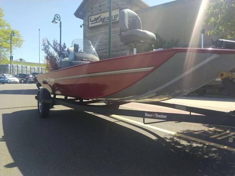 Slide: The Image of 2024 Tracker Bass Tracker Classic XL boat on trailer outside a store. - 2