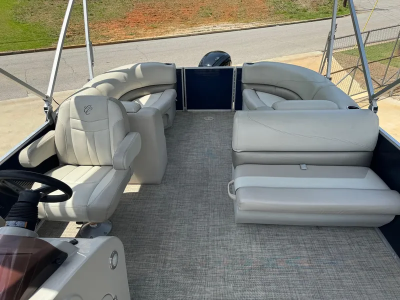 Slide: The Image of 2022 Cypress Cay Seabreeze 232 pontoon boat interior with plush seating and steering console. - 4