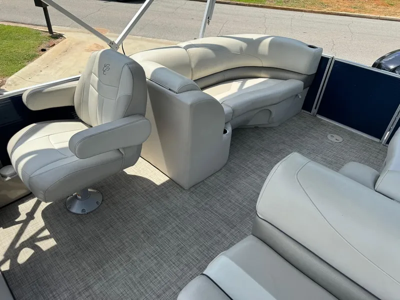 Slide: The Image of 2022 Cypress Cay Seabreeze 232 boat interior with plush seating and captain's chair. - 6
