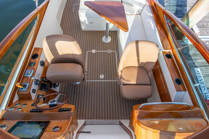 Slide: The Image of 2004 Hinckley Talaria 29 Runabout interior with leather seats and wooden accents. - 12