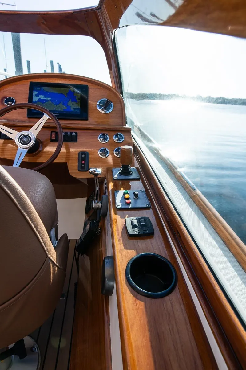 Slide: The Image of Interior of 2004 Hinckley Talaria 29 Runabout with wooden dashboard and steering wheel. - 17