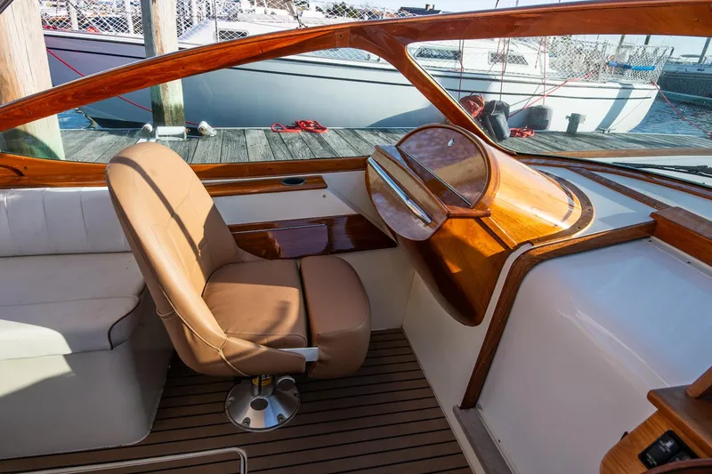 Slide: The Image of 2004 Hinckley Talaria 29 Runabout interior with wooden dashboard and leather seating. - 18