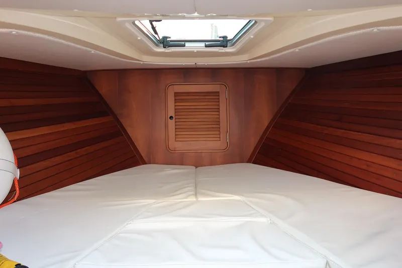 Slide: The Image of Interior cabin of 2004 Hinckley Talaria 29 Runabout with wood paneling and white cushions. - 20