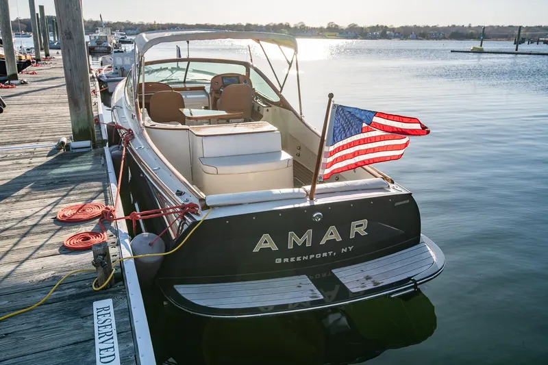 Slide: The Image of 2004 Hinckley Talaria 29 Runabout docked with American flag, Greenport, NY. - 3