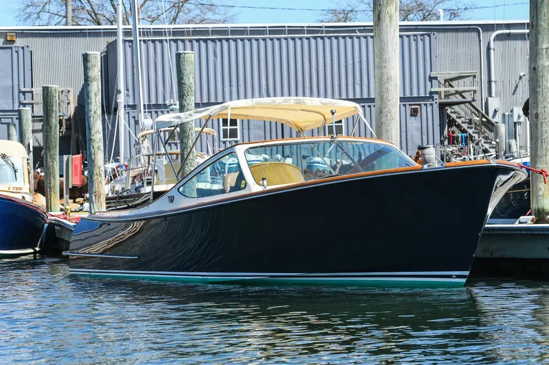 The Image of 2004 Hinckley Talaria 29 Runabout docked in a marina, showcasing sleek design and craftsmanship. - 0