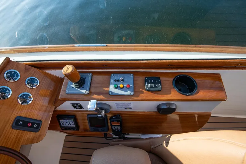 Slide: The Image of 2004 Hinckley Talaria 29 Runabout dashboard with wooden finish and control panel. - 16