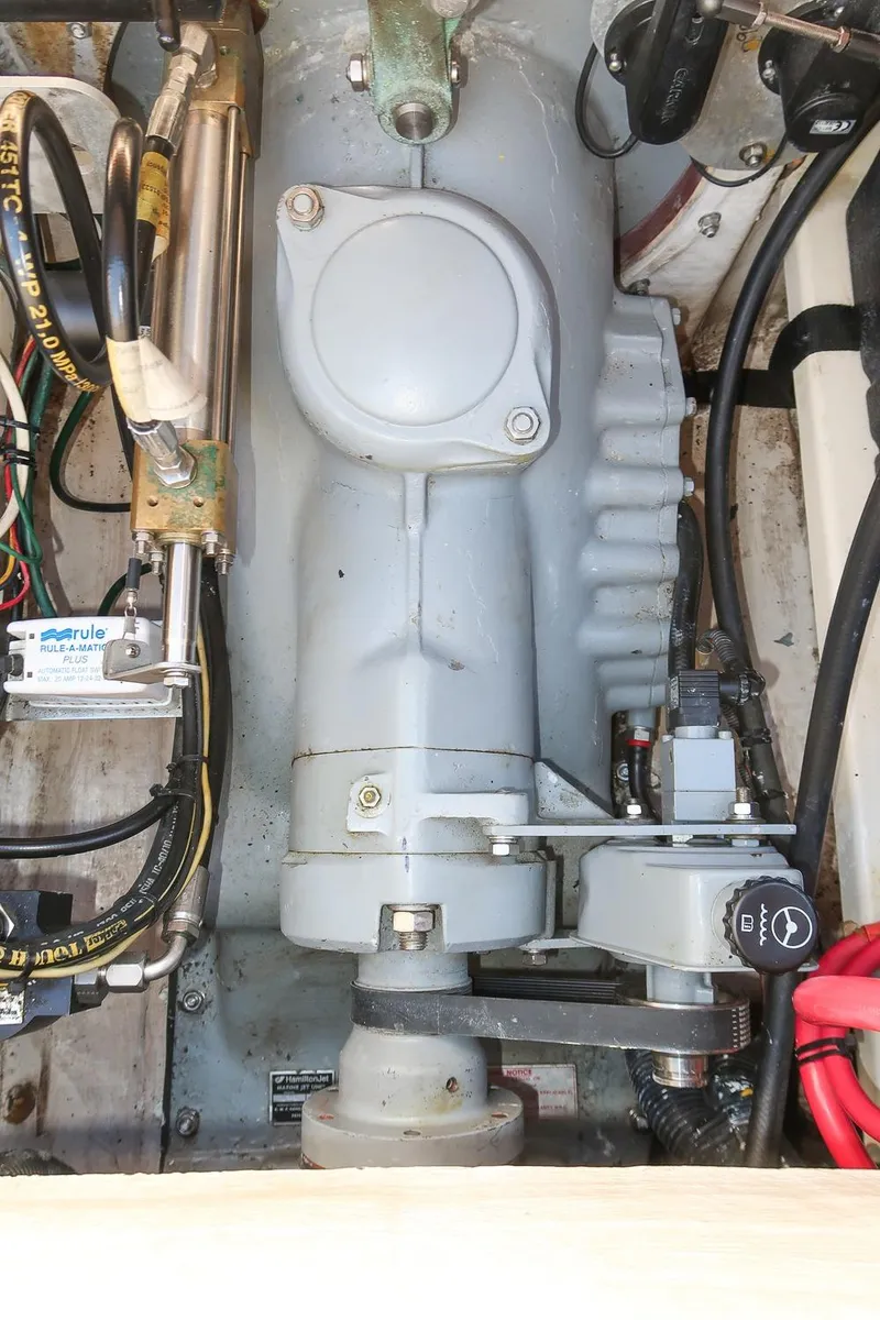 Slide: The Image of Engine compartment of a 2004 Hinckley Talaria 29 Runabout, showcasing mechanical components and wiring. - 28