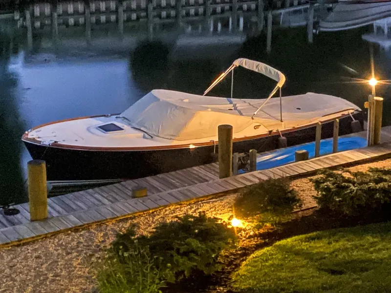 Slide: The Image of 2004 Hinckley Talaria 29 Runabout docked at night, covered and illuminated. - 30