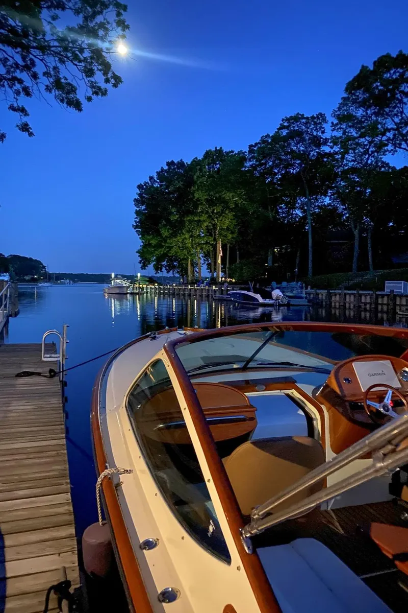 Slide: The Image of 2004 Hinckley Talaria 29 Runabout docked at serene lakeside during twilight. - 31