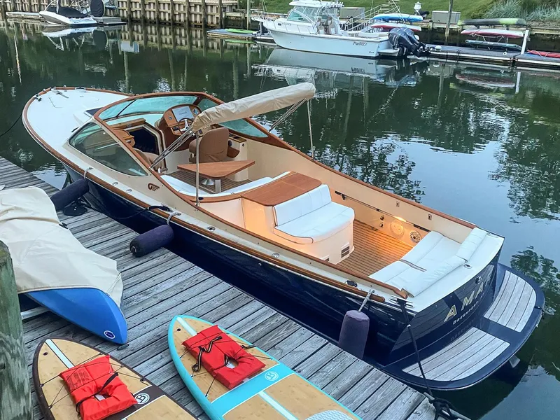 Slide: The Image of 2004 Hinckley Talaria 29 Runabout docked with paddleboards nearby. - 4