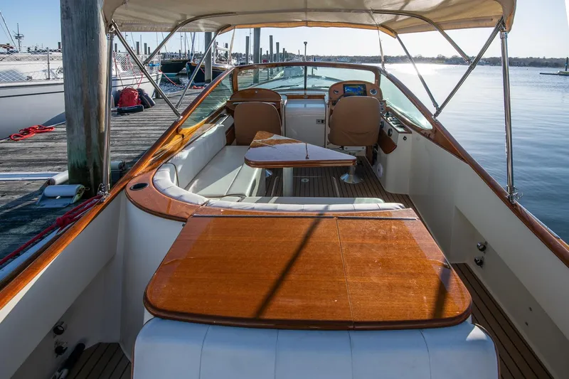 Slide: The Image of 2004 Hinckley Talaria 29 Runabout with wooden deck, docked at marina. - 8