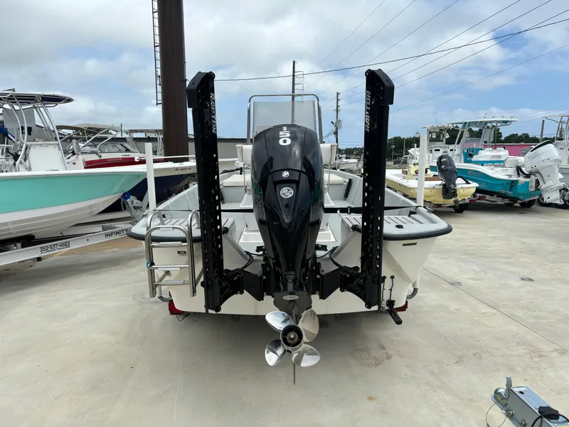 Slide: The Image of 1997 Hydra-Sports 21 boat with outboard motor, parked in a marina. - 11