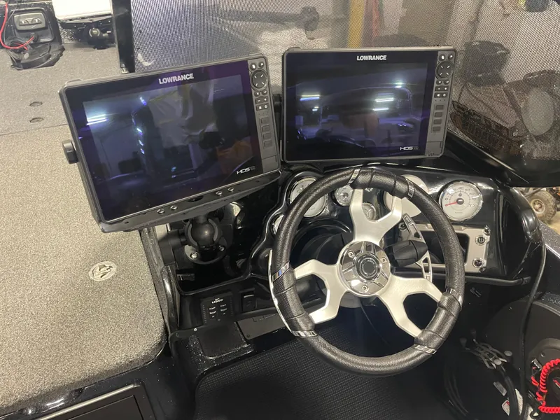 Slide: The Image of 2022 Nitro ZV21 boat dashboard with dual Lowrance HDS displays and steering wheel. - 10