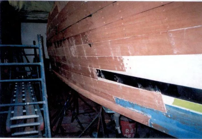 Slide: The Image of 1969 Trojan Sea Voyager Sportfish under restoration in a workshop. - 5