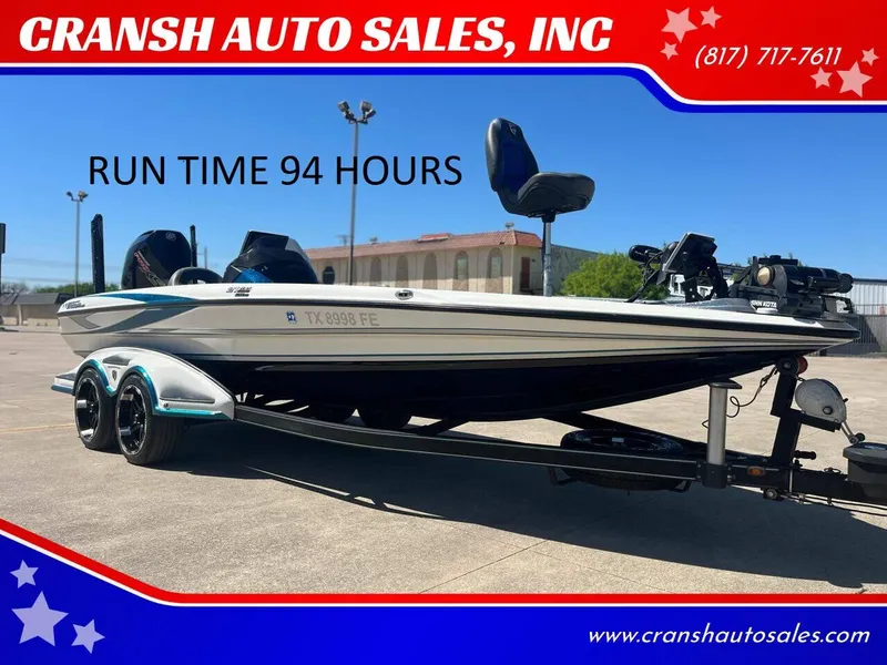 Slide: The Image of 2020 Triton 21 TRXS bass boat on trailer, side view, outdoors. - 0