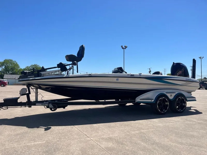Slide: The Image of 2020 Triton 21 TRXS boat with powerful outboard motor on trailer. - 1