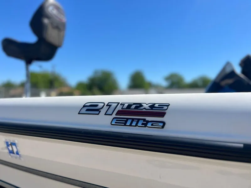 Slide: The Image of 2020 Triton 21 TRXS bass boat on trailer in parking lot. - 10