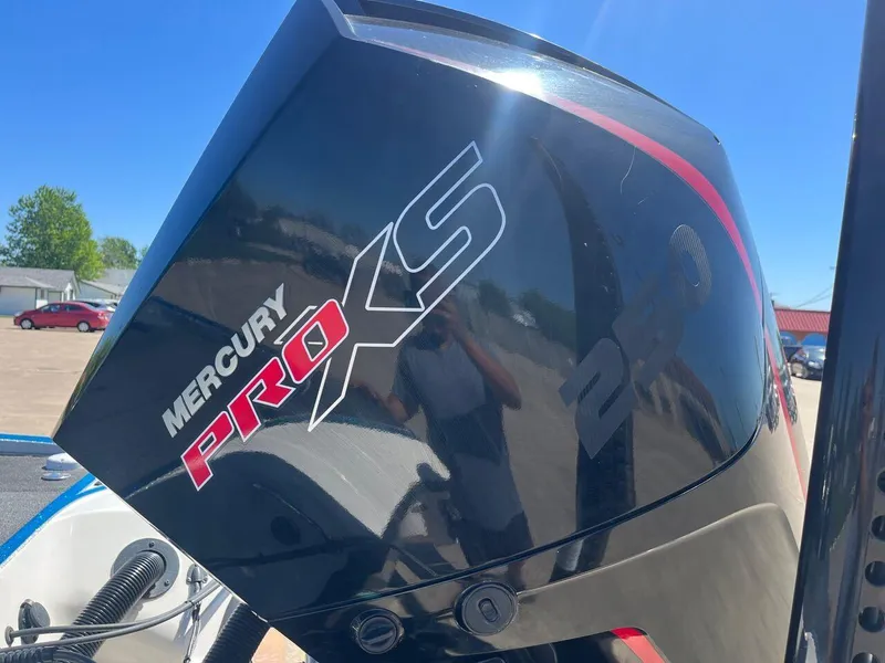 Slide: The Image of 2020 Triton 21 TRXS bass boat on a trailer in a parking lot. - 21