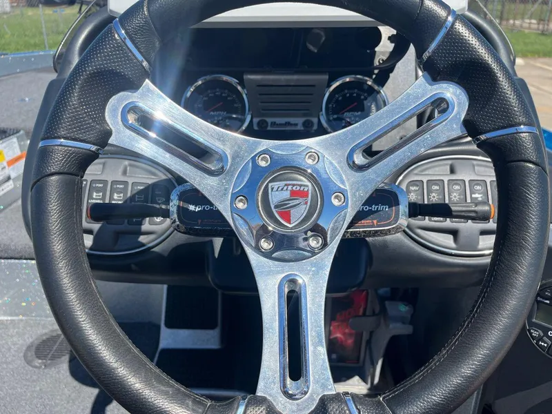 Slide: The Image of 2020 Triton 21 TRXS boat interior with dual gray seats and steering console. - 22