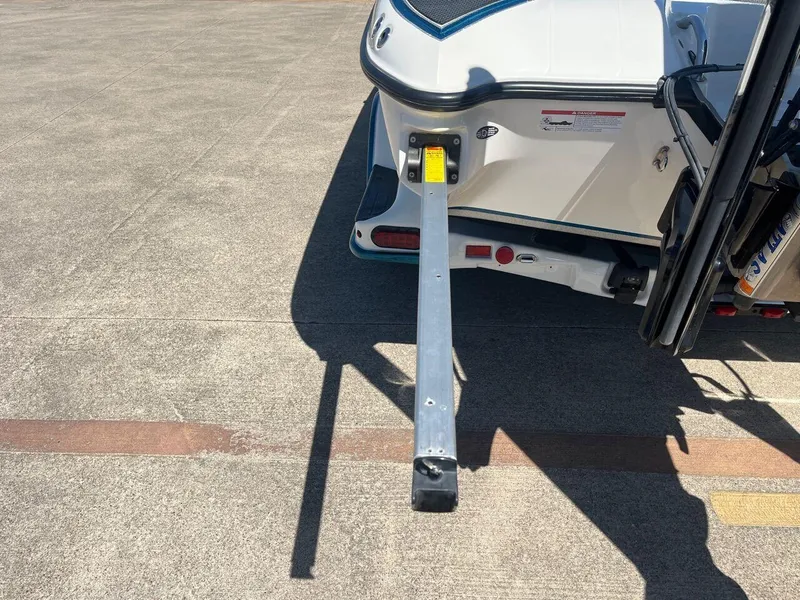 Slide: The Image of 2020 Triton 21 TRXS boat trailer detail with step and wheel. - 28