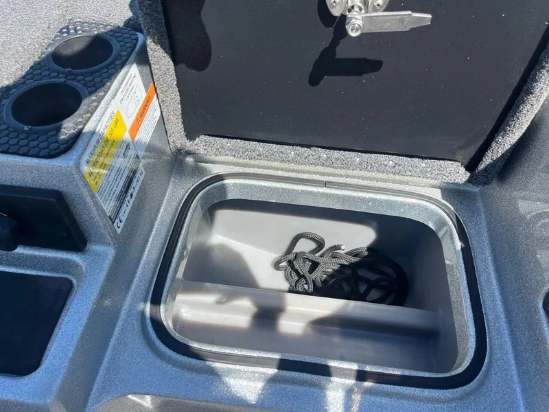 Slide: The Image of Open storage compartment in a 2020 Triton 21 TRXS boat. - 36