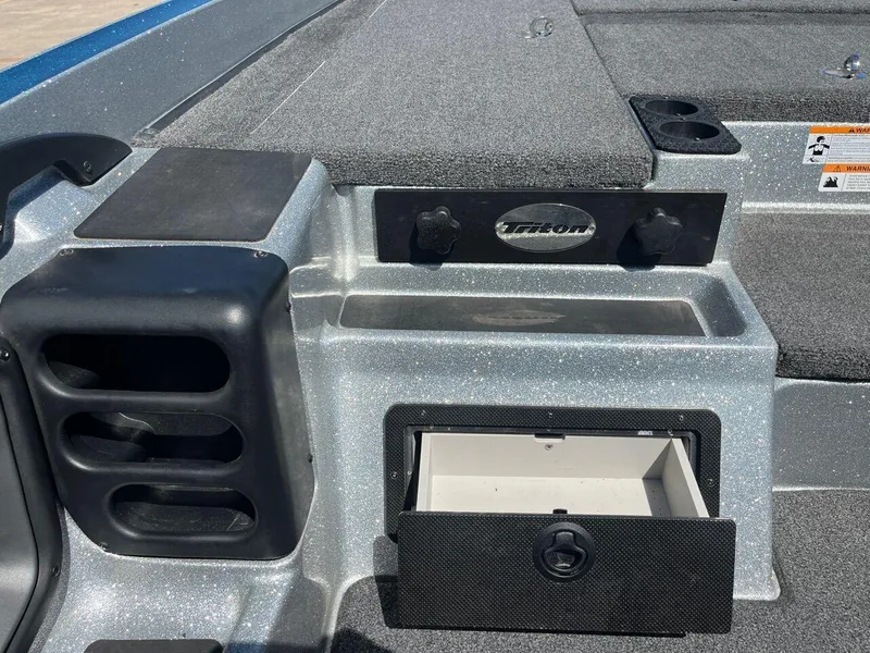 Slide: The Image of 2020 Triton 21 TRXS storage compartment with gray interior. - 49