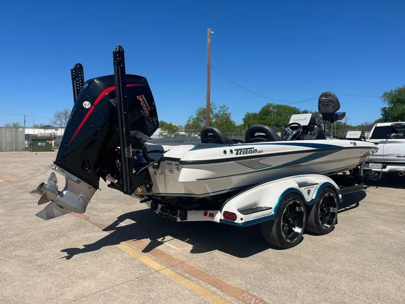 Slide: The Image of 2020 Triton 21 TRXS bass boat on trailer with outboard motor. - 7
