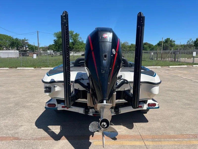 Slide: The Image of 2020 Triton 21 TRXS boat on a trailer under a clear blue sky. - 8