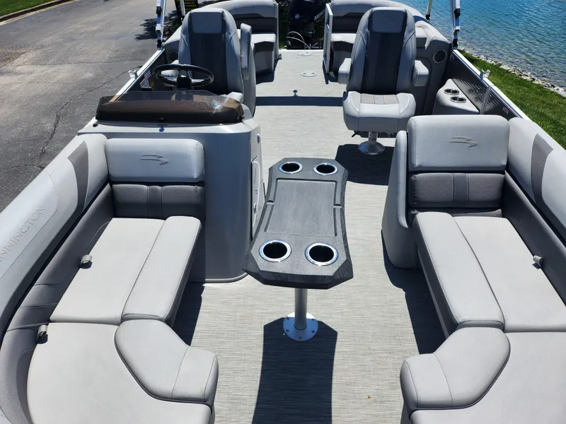 Slide: The Image of 2020 Bennington SX 22 SSRCX pontoon boat interior with gray seating and table. - 10