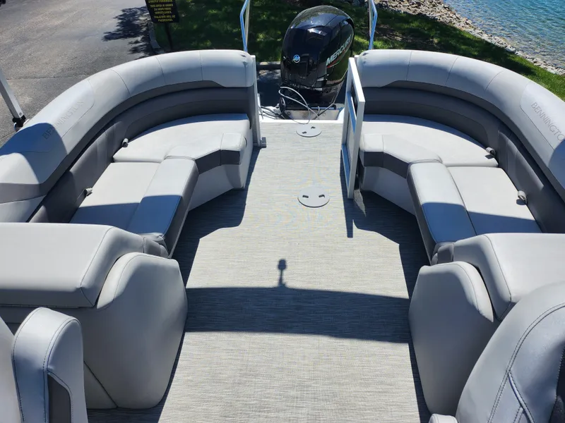 Slide: The Image of 2020 Bennington SX 22 SSRCX pontoon boat interior with plush seating and outboard motor. - 13