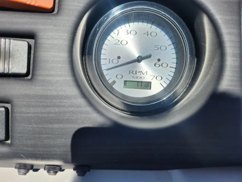 Slide: The Image of Close-up of 2020 Bennington SX 22 SSRCX RPM gauge showing 118 hours. - 19