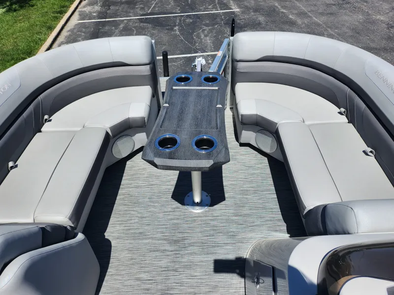 Slide: The Image of 2020 Bennington SX 22 SSRCX pontoon boat interior with gray seating and table. - 21