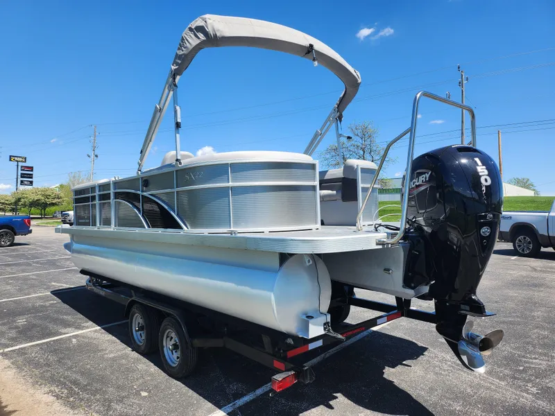 Slide: The Image of 2020 Bennington SX 22 SSRCX pontoon boat with Mercury outboard motor on trailer. - 3