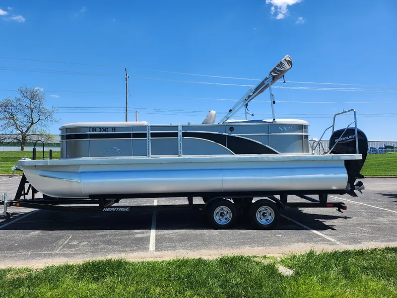 Slide: The Image of 2020 Bennington SX 22 SSRCX pontoon boat on a trailer in a parking lot. - 4