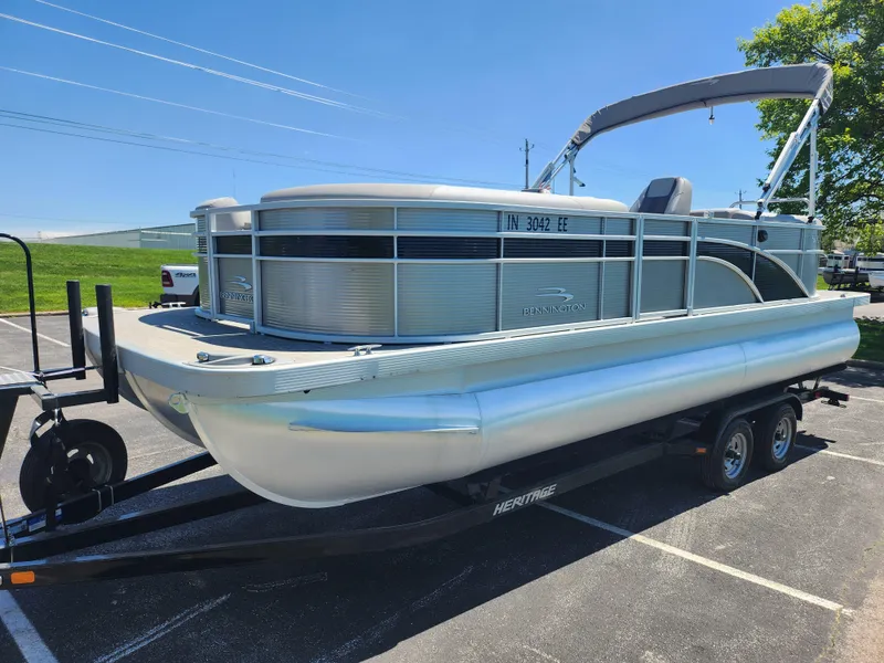 Slide: The Image of 2020 Bennington SX 22 SSRCX pontoon boat on a trailer in a parking lot. - 5